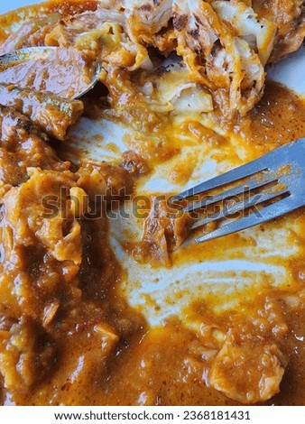 A popular type of food in Malaysia is Roti Canai which is a popular breakfast dish. The picture shows the food being eaten.