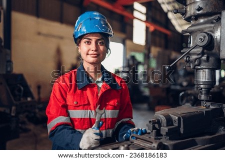 Portrait of female automation engineer standing in modern industrial factory and looking camera in industrial factory. Royalty-Free Stock Photo #2368186183