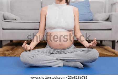 pregnant asian people sitting on yoga mat, she training yoga and meditation, she feeling comfortable and happy, pregnancy health care promotion
 Royalty-Free Stock Photo #2368186783