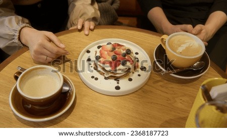 Close-up of couple on date with delicious dishes. Stock footage. Delicious dishes and desserts in restaurant for evening dinner. Couple have desserts at restaurant in evening