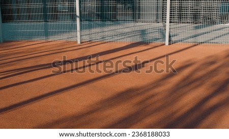 A silhouette playing ball. Media. A man on the playground playing with a ball in the sun.