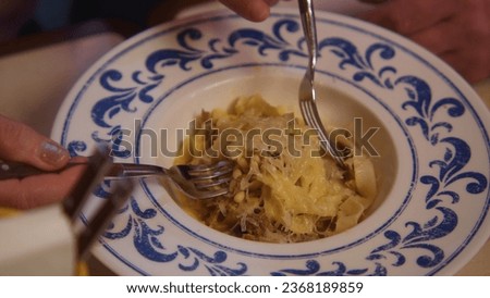 Close-up of man eating delicious dish in restaurant. Stock footage. Beautiful and delicious dish in expensive restaurant. Delicious dish in beautiful plate in restaurant