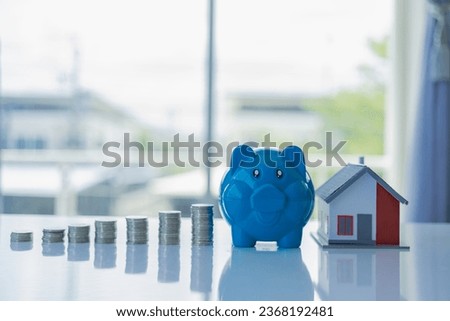 Money saving concept, real estate investment, home loan, reverse mortgage, growing coin pile, saving money coin pile future for home. Close-up pictures