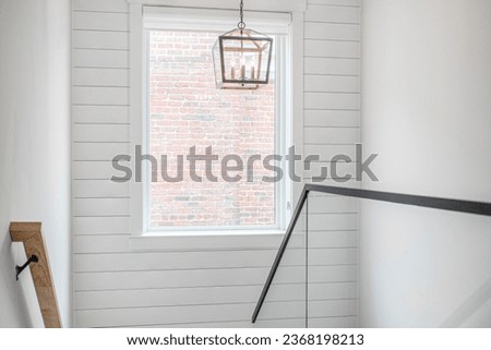 Clean Modern Farmhouse Staircase Interior with Shiplap Wall and Exposed Brick Wall View Royalty-Free Stock Photo #2368198213