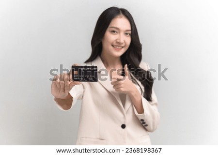 Portrait photo of young beautiful Asian woman feeling happy or surprise shock pointing at credit card on white background can use for advertising or product presenting concept.