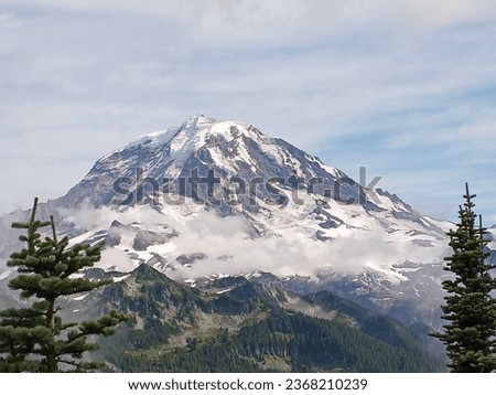Mount Rainier National Park mountain view with trees an clouds. Royalty-Free Stock Photo #2368210239