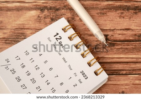 December 2023 - Closeup of a small desktop calendar with wooden table background, time and business concept Royalty-Free Stock Photo #2368213329
