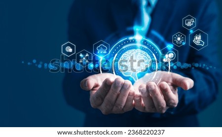 Businessman is holding icons on a virtual screen displaying a Business Analytics and Data Management System enhanced with AI capabilities, covering finance, operations, sales, and marketing