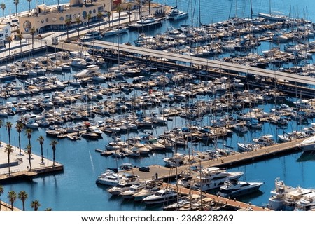 The view from above as Hundreds of seagoing vessels sit in this picturesque harbor, forming a unique picture of tranquility and luxury. Away from the hustle and bustle of the city, boats peacefully 