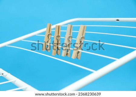 Close-up of wooden clothespins on a drying rack Royalty-Free Stock Photo #2368230639