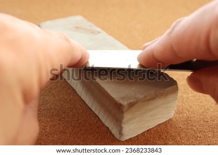 sharpen a knife with a whetstone