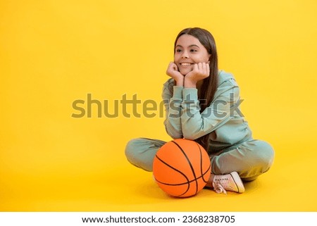 Skilled teen girl playing the basketball. Competitive teen girl playing basketball. teen girl practicing basketball skills. Teen girl excelling in basketball. Active childhood in sports
