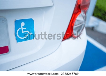 car with a disabled sticker on, automobile with disability license plate wheelchair sign