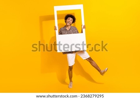 Full size photo of childish funky person wear leopard shirt white shorts fooling around in frame isolated on yellow color background
