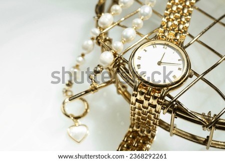 Stylish presentation of elegant wristwatch and pearl necklace on white background, closeup Royalty-Free Stock Photo #2368292261