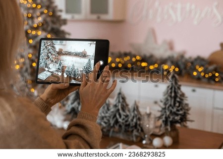 winter holidays, diy and hobby concept - close up of woman with tablet pc computer decorates home for Christmas