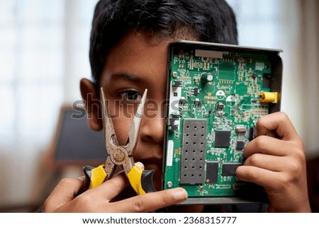 Smart little boy holding electronic circuit board