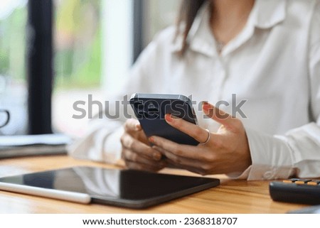 Select focus on woman hands using smartphone texting messages, chatting in social during break