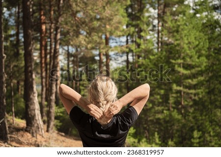 Beautiful woman against the background of a pine forest, forest baths, the idea of restoring health Royalty-Free Stock Photo #2368319957