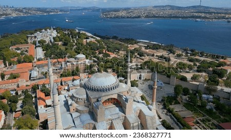 Hagia Sophia in Istanbul. A world-famous monument of Byzantine architecture. Aerial drone view. Light clouds. Istanbul and the Bosphorus Canal can be seen behind.