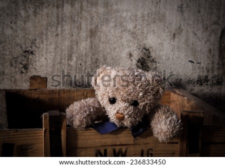 Teddy bear alone sitting in box ,Still life photography on vintage abandon concept