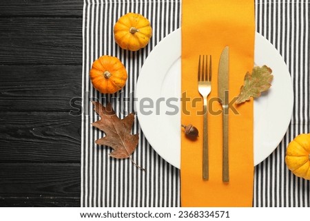 Autumn table setting, pumpkins and dry leaves, flat lay. Space for text