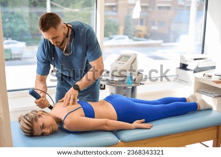 Physiotherapist making trigger point therapy to female patient Royalty-Free Stock Photo #2368343321