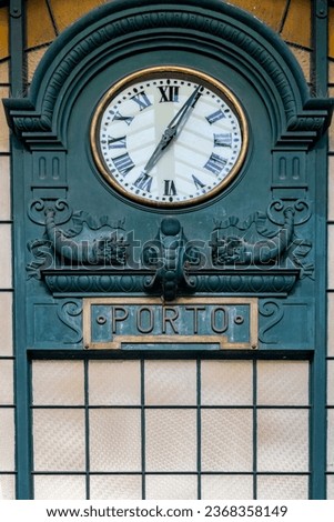 Porto, Portugal Sept 20, 2023 The clock hanging in the interior of the Sao Bento Train station.