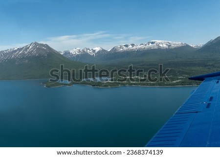 Aerial view of Port Alsworth, Alaska within Lake Clark National Park and Preserve. Private Port Alsworth Airport, public Wilder Natwick Airport, Tanalian Mountain, Chig­mit Mountains, Hardenburg bay. Royalty-Free Stock Photo #2368374139