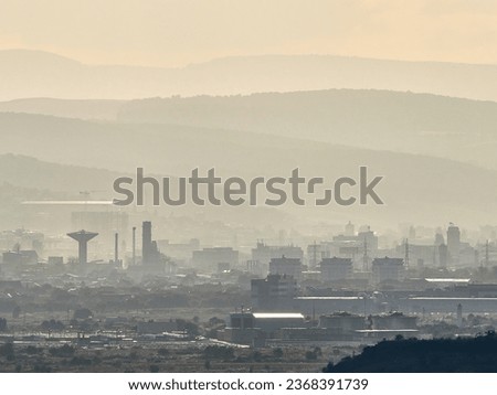 Industrial perspective over Cluj city, aerial view. Factory infrastructure. Industry metallurgical plant dawn smoke smog emissions bad ecology