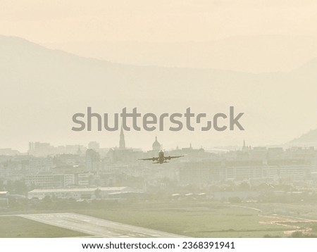 Avram Iancu airport runway in Cluj with plane taking off. East side view of Cluj Napoca, Romania. Passenger plane is taking off during a wonderful sunset. Royalty-Free Stock Photo #2368391941
