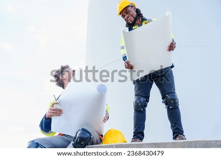 Architectural engineering working and maintenance with wind turbine blueprint drawing of wind turbines at windmill field farm. Alternative renewable energy for clean energy concept.