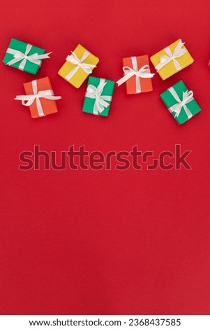 multi-colored gifts on a red background. flat lay. christmas, birthday or holiday concept. vertical picture