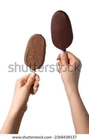 Woman holding delicious chocolate covered ice cream on stick against white background