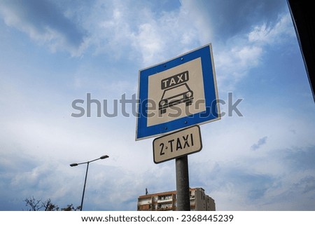 TAxi parking sign shot against sky in the city. High quality photo