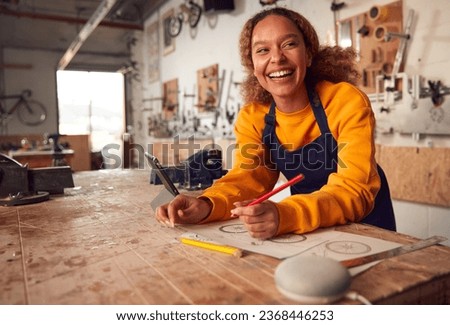 Female Craftsman In Carpentry Workshop For Bamboo Bicycles Using Digital Tablet And Smart Speaker Royalty-Free Stock Photo #2368446253