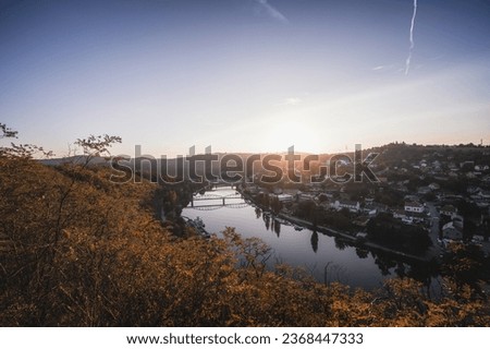 View of the town of Davle from a rock above the Vltava river near Prague. Autumn sunset.