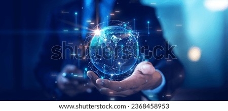 Male businessman holds abstract world with rapid growth of digital and economic technology. business contact concept Global Internet network communication connection. Internet of Things IOT. Royalty-Free Stock Photo #2368458953
