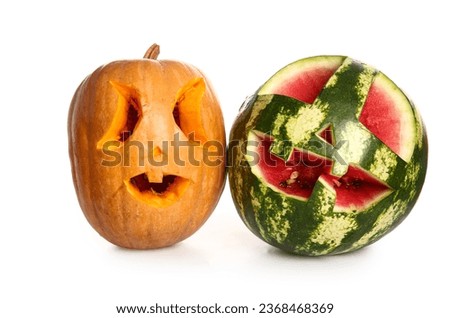 Carved pumpkin and watermelon for Halloween on white background
