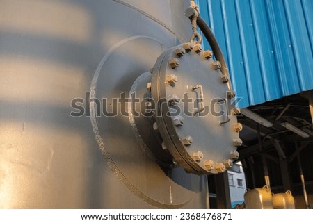 Man hole of tank and bona pipe on the power plant project. The photo is suitable to use for industry background photography, power plant poster and electricity content media.