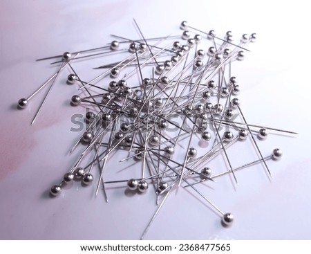 Sewing straight pin with silver head, white background