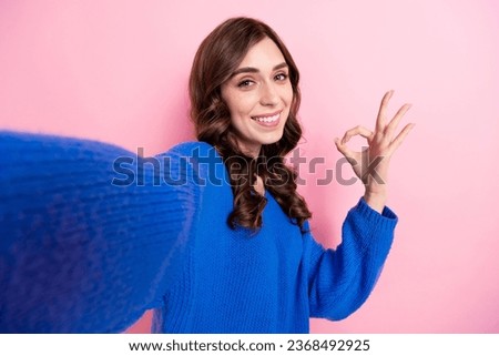 Photo portrait of pretty young girl take selfie photo show okey sign dressed stylish blue outfit isolated on pink color background