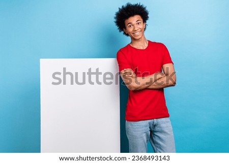 Photo of young guy crossed hands confident wear red stylish t shirt hipster paper white board empty space isolated on blue color background