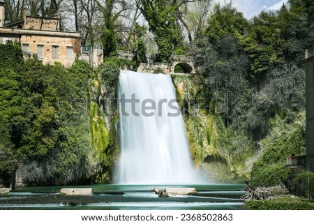 Conceptual photo spring panoramic with waterfall in Isola del Liri medieval village in central Italy in Europe. Historical tourist destination. Water flowers within a colorful country full of joy Royalty-Free Stock Photo #2368502863
