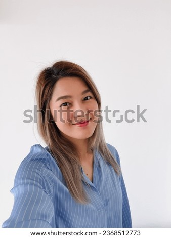 Happy pretty Thai asian office women take selfie, smiling and looking at camera feeling good, isolated on white background.