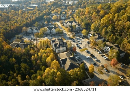Aerial view of new apartment houses between yellow trees in South Carolina suburban area in fall season. Real estate development in american suburbs Royalty-Free Stock Photo #2368524711