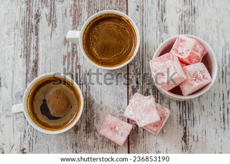 Turkish coffee with Turkish delight on white wooden background Royalty-Free Stock Photo #236853190