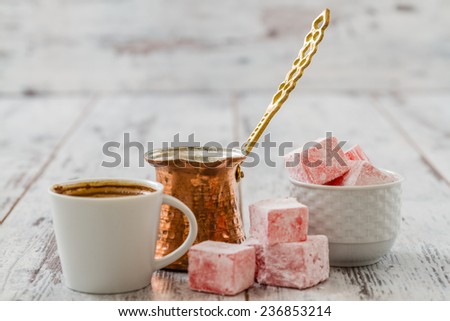 Turkish coffee with Turkish delight and coffee pot on white wooden background Royalty-Free Stock Photo #236853214