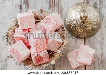 Rose flavoured Turkish delight in traditional silver bowl on wooden white background Royalty-Free Stock Photo #236853217