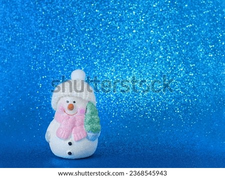 snowman with christmas tree on blue  background